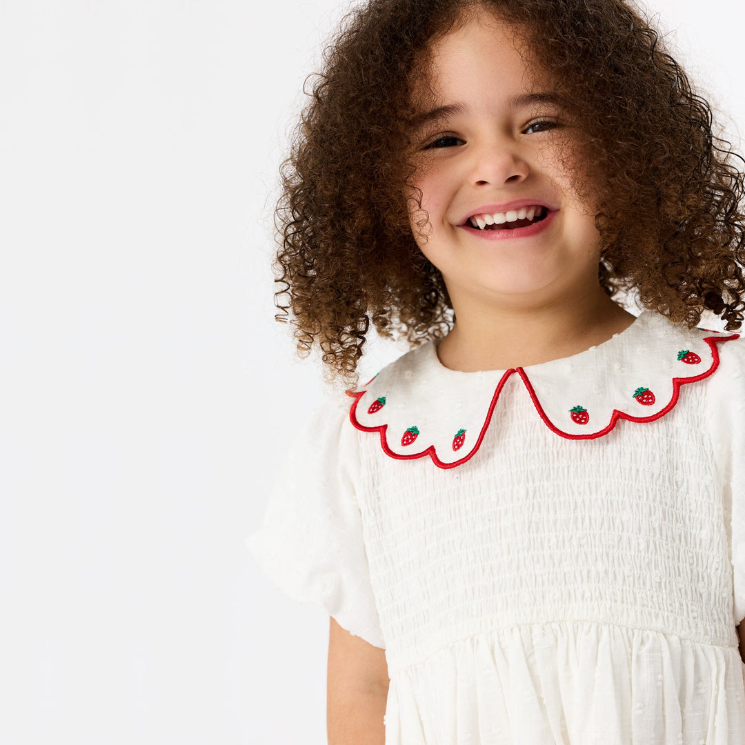 Sweet Strawberry Flo Smocked Dress | White — lifestyle view
